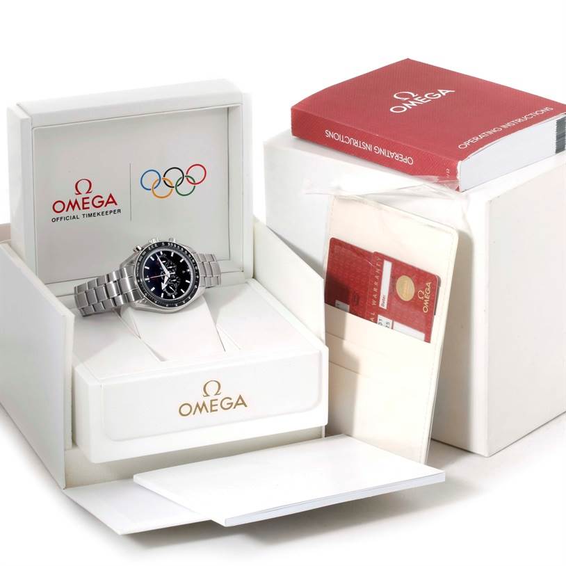 The Omega Speedmaster 321.30.44.52.01.001 Men
s Stainless Steel Black Dial 321.30.44.52.01.001 Men
s Stainless Steel Black Dial watch is shown in its open box with manuals and warranty cards next to it.