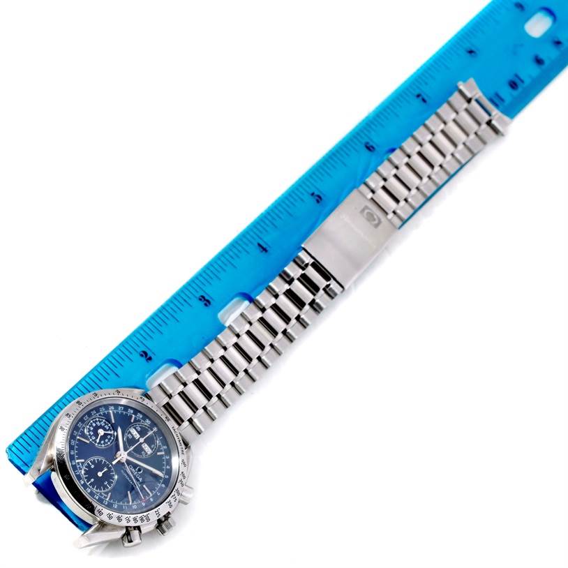 The Omega Speedmaster 3523.80.00 Men's Stainless Steel Blue Dial 3523.80.00 Men's Stainless Steel Blue Dial watch is shown from an overhead angle, highlighting its face and metal bracelet against a ruler for scale.