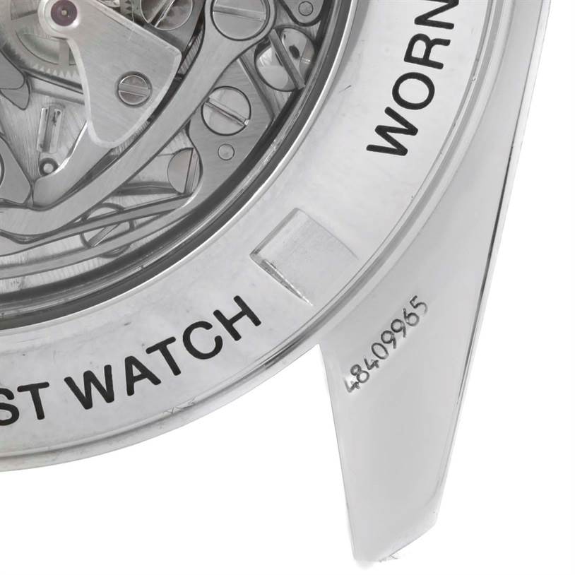 The image shows the back view of an Omega Speedmaster 3572.50.00 Men
s Stainless Steel Black Dial 3572.50.00 Men
s Stainless Steel Black Dial, highlighting its intricate movement and part of the engraved case.