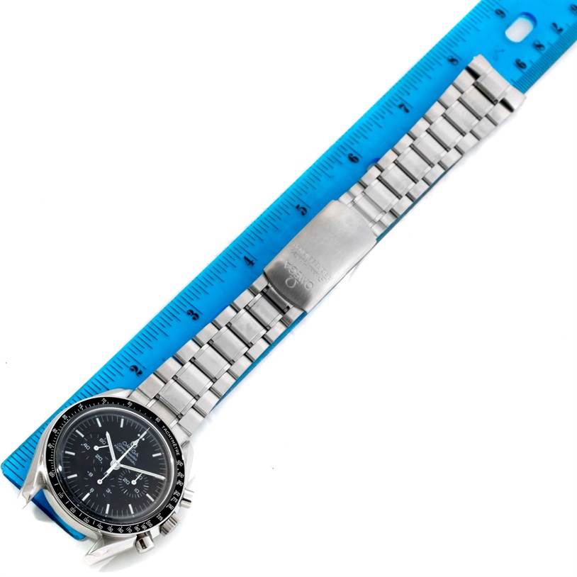 The Omega Speedmaster 3572.50.00 Men
s Stainless Steel Black Dial 3572.50.00 Men
s Stainless Steel Black Dial watch is shown from a top-down angle with the full stainless steel bracelet displayed next to a ruler.
