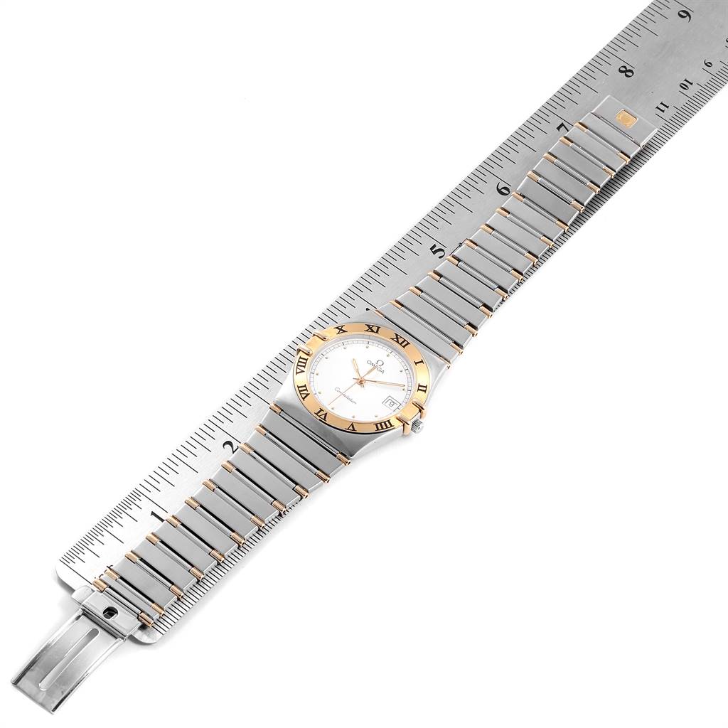 The image shows an Omega Constellation 396.1076 Men's Steel and Gold (two tone) White Dial 396.1076 Men's Steel and Gold (two tone) White Dial watch laid flat, measured with a ruler, displaying the bracelet, bezel, and dial.