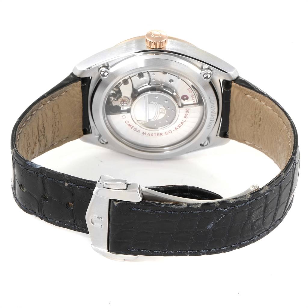 The image shows the back view of an Omega Constellation 130.23.39.21.03.001 Men's Steel and Gold (two tone) Blue Dial 130.23.39.21.03.001 Men's Steel and Gold (two tone) Blue Dial watch, highlighting its transparent case back, leather strap, and clasp.