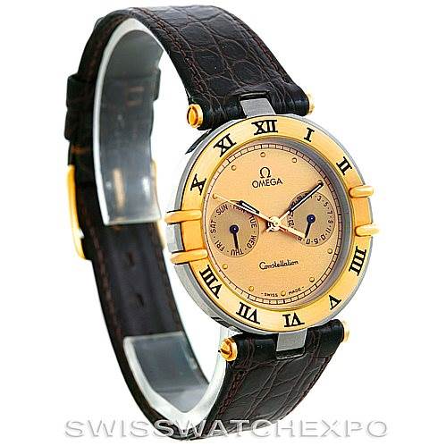 The image shows an Omega Constellation Men's Steel and Gold (two tone) Champagne Dial Men's Steel and Gold (two tone) Champagne Dial watch from a front-left angle, highlighting the brown leather strap, gold bezel, and dial details.
