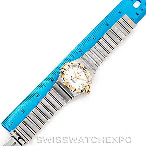 The image shows an Omega Constellation 1302.30.00 Men's Steel and Gold (two tone) Silver Dial 1302.30.00 Men's Steel and Gold (two tone) Silver Dial watch laid flat next to a ruler, displaying the strap and face from a top-down angle.