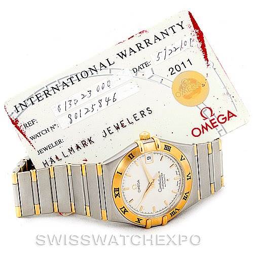 The image shows an Omega Constellation 1302.30.00 Men's Steel and Gold (two tone) Silver Dial 1302.30.00 Men's Steel and Gold (two tone) Silver Dial watch at a slight angle, revealing the face and bracelet, alongside its international warranty card.