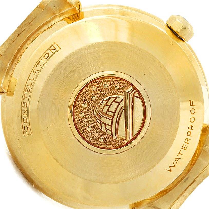 This image shows the case back of an Omega Constellation 14365 Men's Yellow Gold Champagne Dial 14365 Men's Yellow Gold Champagne Dial watch, highlighting its gold finish and the engraving of an observatory.