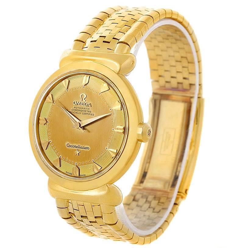 The image shows an angled view of an Omega Constellation 14365 Men's Yellow Gold Champagne Dial 14365 Men's Yellow Gold Champagne Dial watch, highlighting its golden dial, bezel, and bracelet.