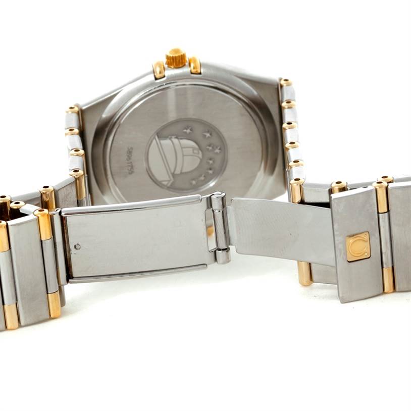 The image shows the rear side of the Omega Constellation 1312.30.00 Men's Steel and Gold (two tone) Silver Dial 1312.30.00 Men's Steel and Gold (two tone) Silver Dial watch and its clasp, showcasing the back case and part of the bracelet.