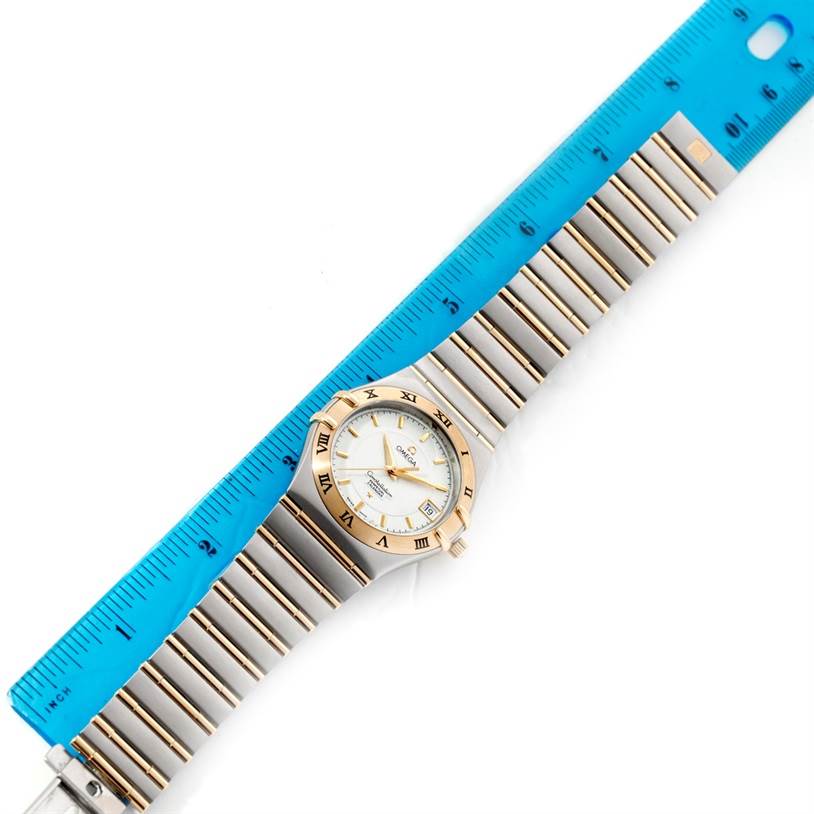 This image shows the Omega Constellation 1252.30.00 Men's Steel and Gold (two tone) Silver Dial 1252.30.00 Men's Steel and Gold (two tone) Silver Dial watch from an overhead angle, including the full bracelet and a ruler for measurement.