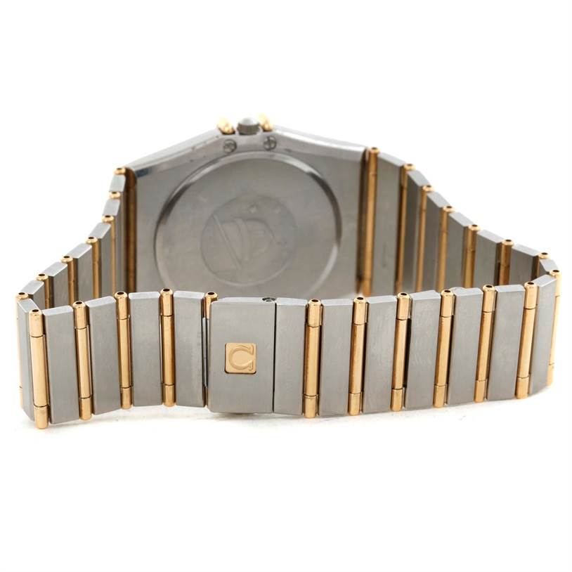 The image shows the back view of a Constellation model by Omega, highlighting its bi-metal bracelet and case back.