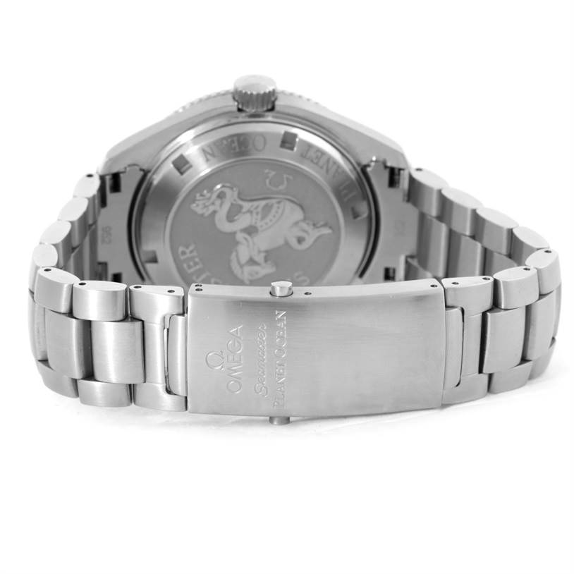 The image shows the back case and stainless steel bracelet of the Omega Seamaster Planet Ocean watch, highlighting the clasp and rear engravings.
