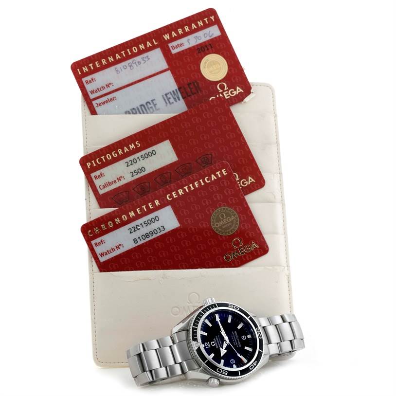 The image shows an Omega Planet Ocean 2201.50.00 Men
s Stainless Steel Black Dial 2201.50.00 Men
s Stainless Steel Black Dial watch and its warranty, pictogram, and chronometer certificate cards.