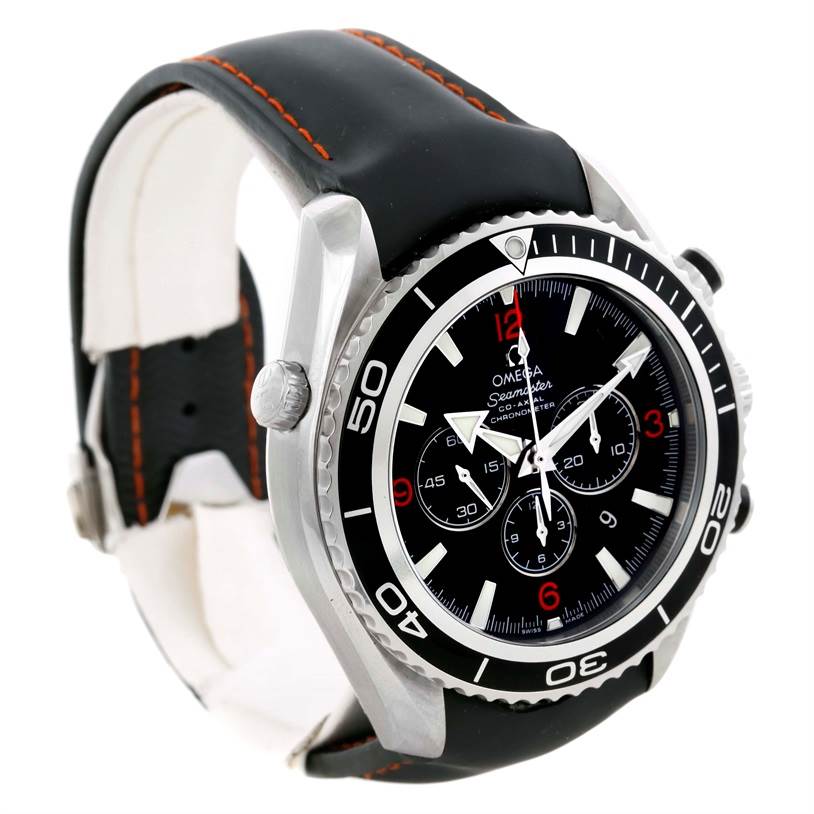 The image shows an Omega Planet Ocean 2210.51.00 Men
s Stainless Steel Black Dial 2210.51.00 Men
s Stainless Steel Black Dial watch at a three-quarter angle, highlighting its black dial, bezel, and black strap with orange stitching.