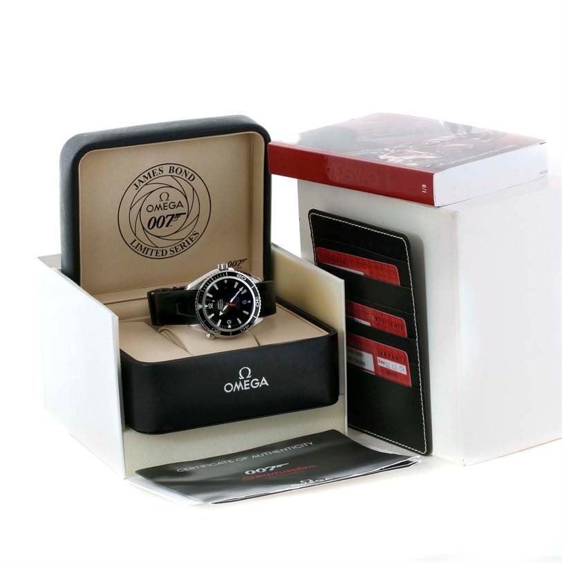 The image shows an Omega Planet Ocean 2907.50.91 Men
s Stainless Steel Black Dial 2907.50.91 Men
s Stainless Steel Black Dial model watch with a leather strap, displayed in its box along with warranty cards and a manual.