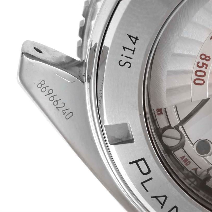 The image shows a close-up of the case back of an Omega Planet Ocean 232.30.46.21.01.002 Men
s Stainless Steel Black Dial 232.30.46.21.01.002 Men
s Stainless Steel Black Dial watch, highlighting part of the movement and lug.