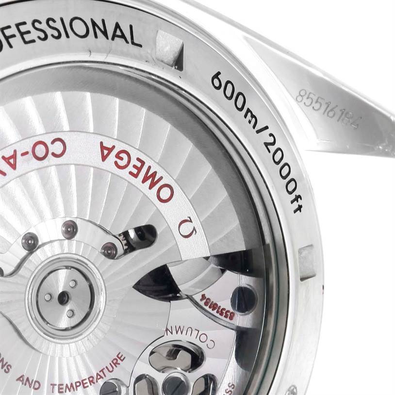 The image shows the back view of the Omega Planet Ocean 232.30.46.51.01.001 Men
s Stainless Steel Black Dial 232.30.46.51.01.001 Men
s Stainless Steel Black Dial watch, featuring the inner mechanisms and the inscription of its water resistance.