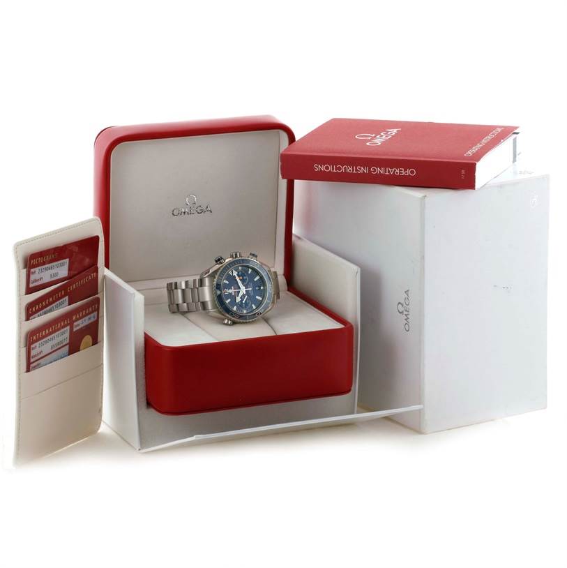 This image shows an Omega Planet Ocean 232.90.46.51.03.001 Men
s Titanium Blue Dial 232.90.46.51.03.001 Men
s Titanium Blue Dial watch in its box, along with the operating instructions and cards.