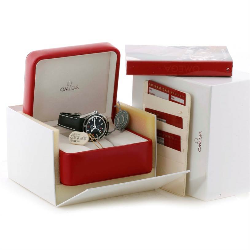 The Omega Planet Ocean 2201.51.00 Men
s Stainless Steel Black Dial 2201.51.00 Men
s Stainless Steel Black Dial watch is shown in its box at an angle, along with warranty cards and a manual.