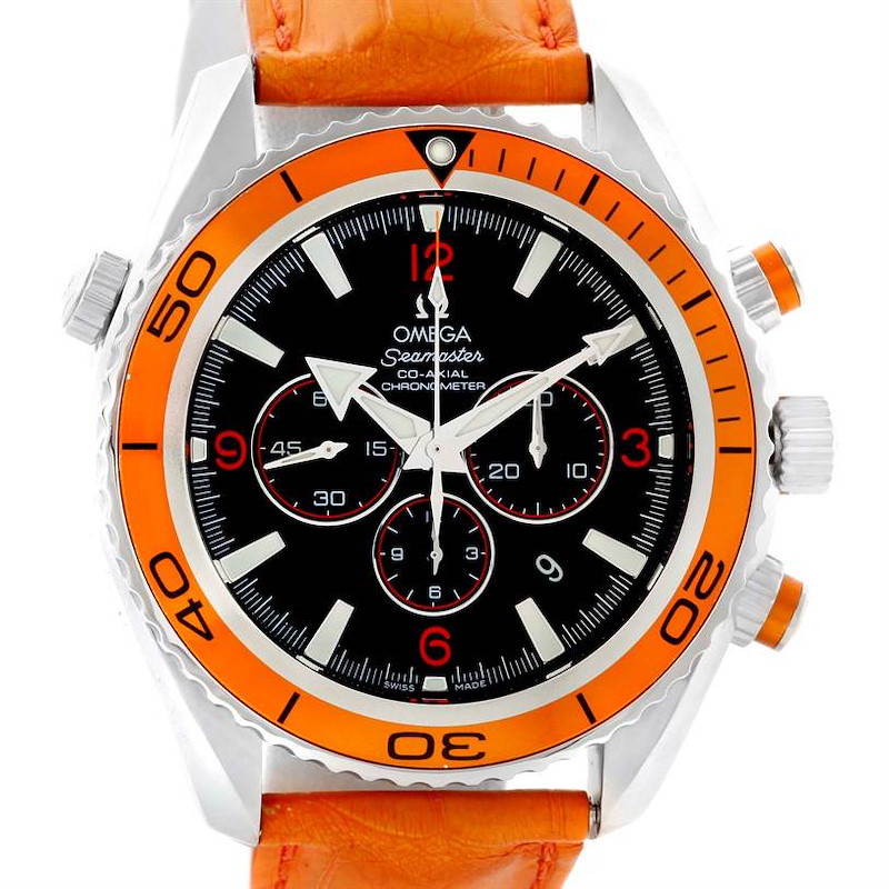 The image shows a front view of the Omega Planet Ocean watch, showcasing its orange bezel, black dial, and orange leather strap.