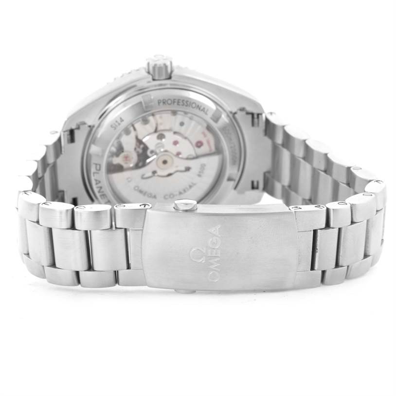 The image shows the case back and bracelet of the Omega Planet Ocean 232.30.42.21.01.001 Men
s Stainless Steel Black Dial 232.30.42.21.01.001 Men
s Stainless Steel Black Dial watch at an angle highlighting the clasp and interior mechanisms.