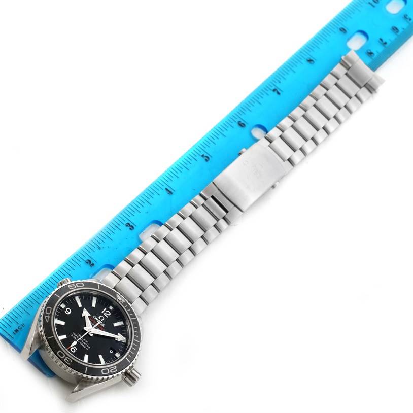 The Omega Planet Ocean 232.30.42.21.01.001 Men
s Stainless Steel Black Dial 232.30.42.21.01.001 Men
s Stainless Steel Black Dial watch is shown from an overhead angle, displaying the face, bezel, and metal strap alongside a ruler for scale.