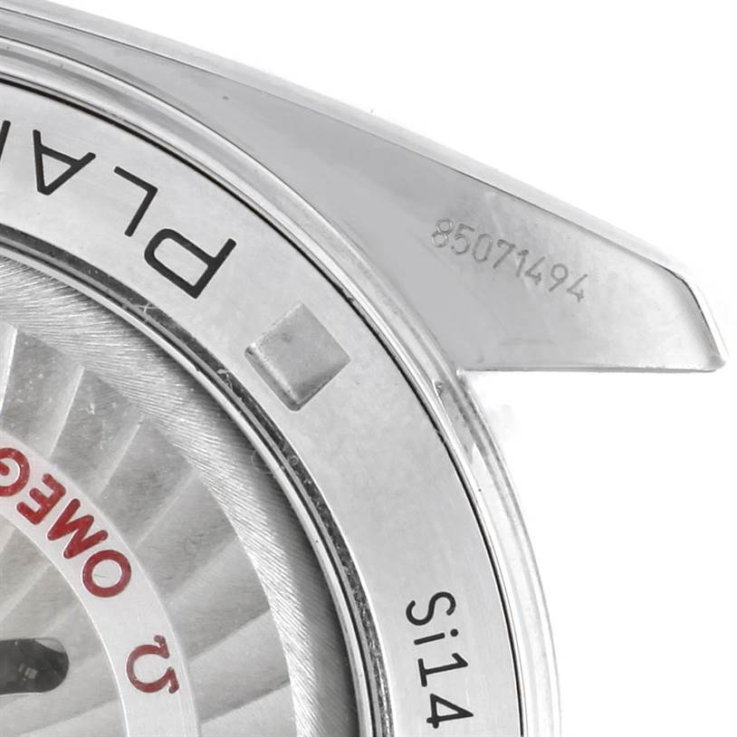 The image shows a close-up of the Omega Planet Ocean 232.30.46.51.01.003 Men
s Stainless Steel Black Dial 232.30.46.51.01.003 Men
s Stainless Steel Black Dial watch
s bezel, partial dial, and serial number engraving.