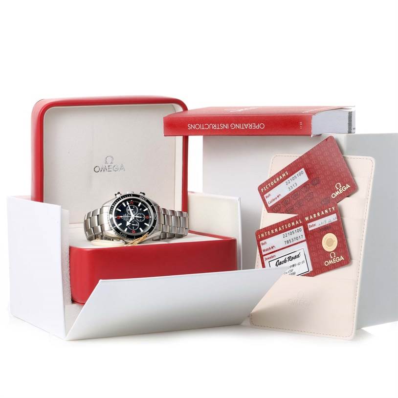 The image shows the Omega Planet Ocean 2210.51.00 Men
s Stainless Steel Black Dial 2210.51.00 Men
s Stainless Steel Black Dial watch in its box along with warranty cards and an instruction manual.