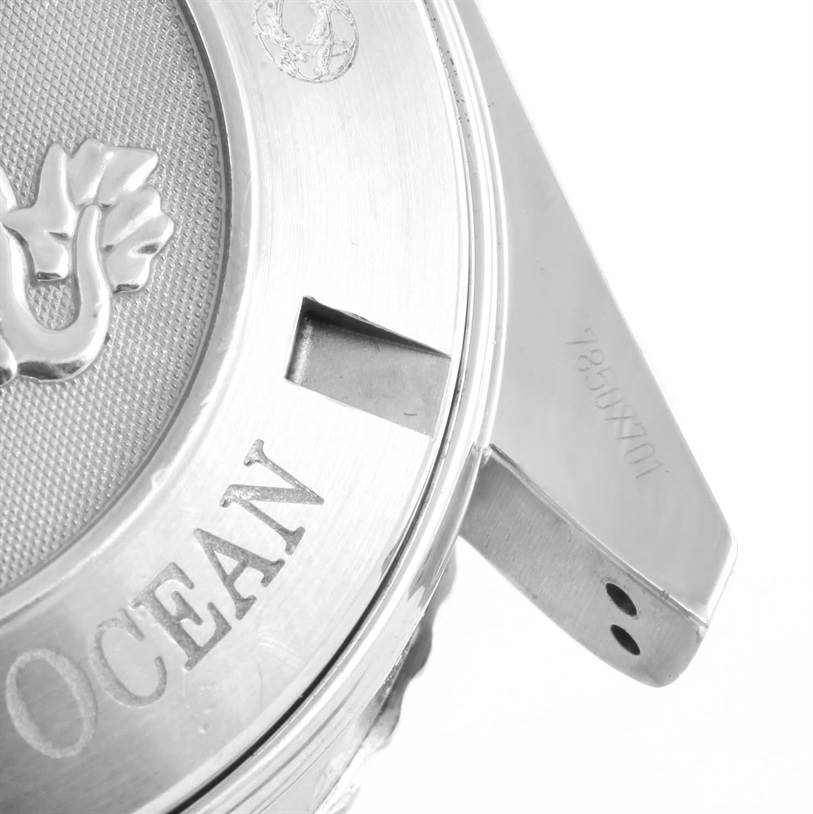 This image shows a close-up of the case back and lug of an Omega Planet Ocean 2210.51.00 Men
s Stainless Steel Black Dial 2210.51.00 Men
s Stainless Steel Black Dial watch, highlighting the engraved text and logo.