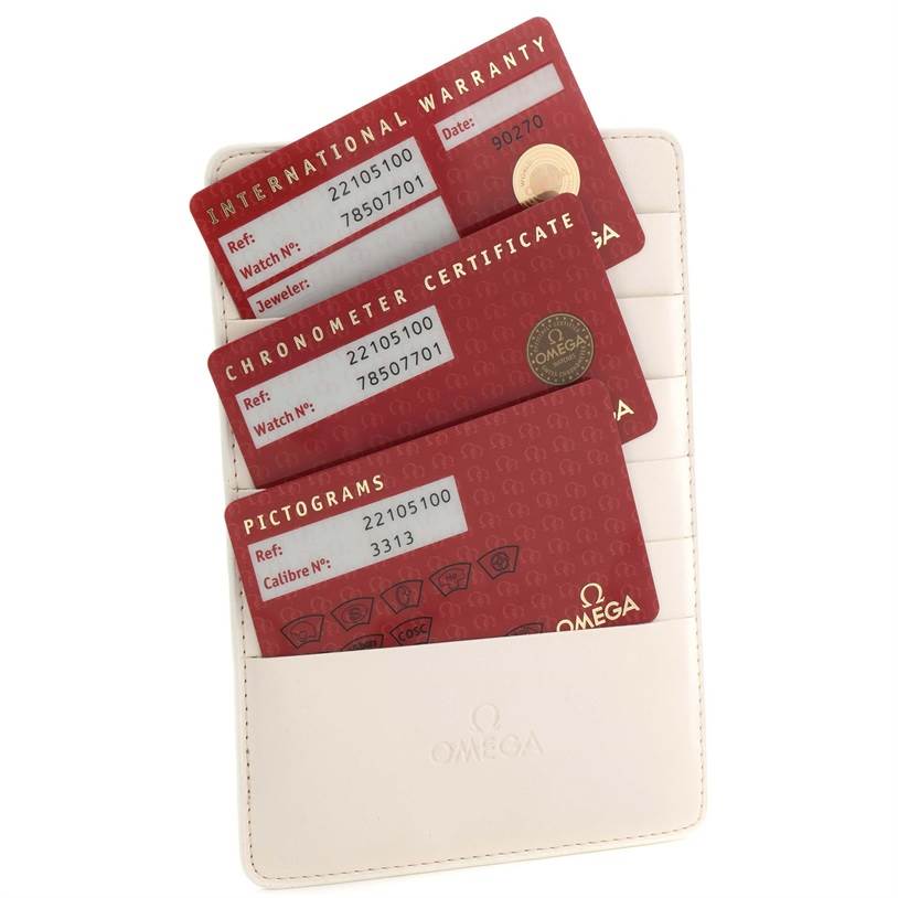 The image shows the warranty cards and certificates for the Omega Planet Ocean 2210.51.00 Men
s Stainless Steel Black Dial 2210.51.00 Men
s Stainless Steel Black Dial watch, arranged in a holder.