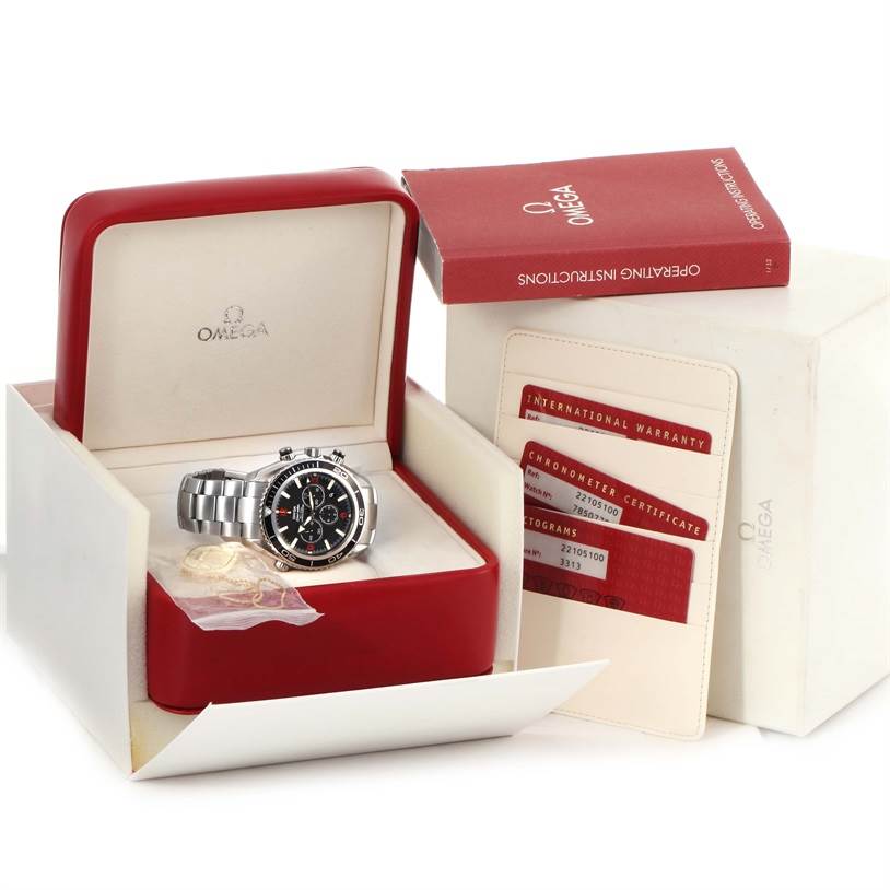 The image shows an Omega Planet Ocean 2210.51.00 Men
s Stainless Steel Black Dial 2210.51.00 Men
s Stainless Steel Black Dial watch at a front angle, inside its box with accompanying documents and an instruction manual.