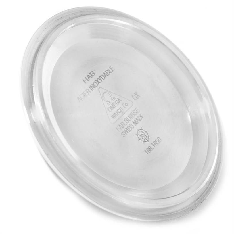 The image shows the underside of a metal case back for an Omega Planet Ocean 2200.50.00 Men
s Stainless Steel Black Dial 2200.50.00 Men
s Stainless Steel Black Dial watch.