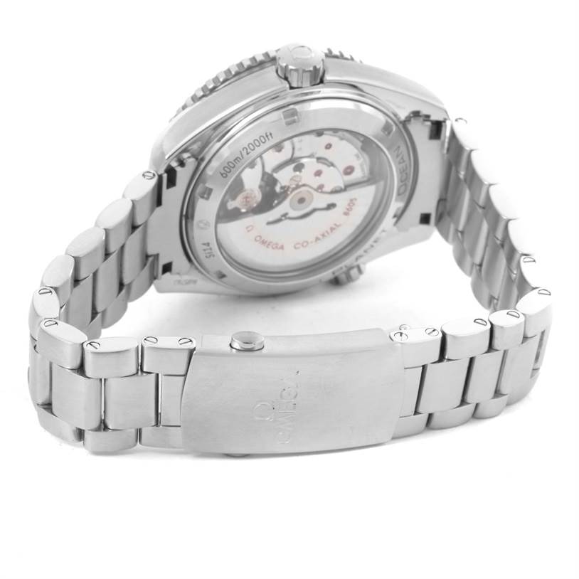 The image shows the case back and part of the stainless steel bracelet of the Omega Planet Ocean 232.30.44.22.01.001 Men
s Stainless Steel Black Dial 232.30.44.22.01.001 Men
s Stainless Steel Black Dial watch, angle emphasizing the movement.