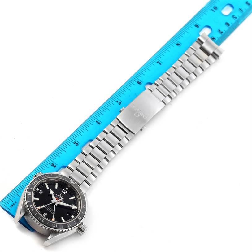 The Omega Planet Ocean 232.30.44.22.01.001 Men
s Stainless Steel Black Dial 232.30.44.22.01.001 Men
s Stainless Steel Black Dial watch is shown flat, alongside a ruler, displaying the face, bezel, bracelet, and clasp.