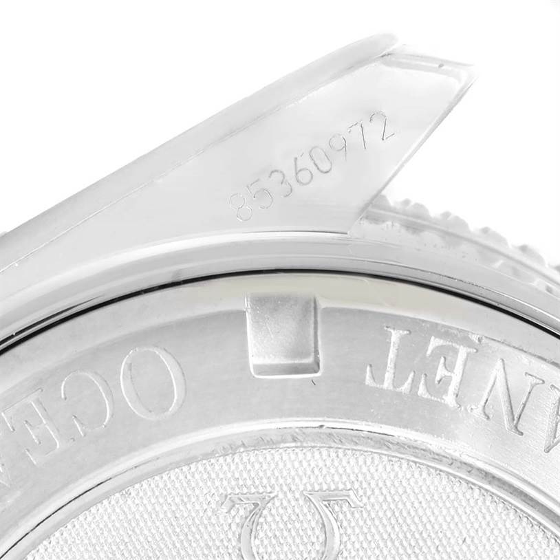 The image shows a close-up of the backside and part of the bezel of the Omega Planet Ocean 2209.50.00 Men's Stainless Steel Black Dial 2209.50.00 Men's Stainless Steel Black Dial watch, highlighting the serial number.