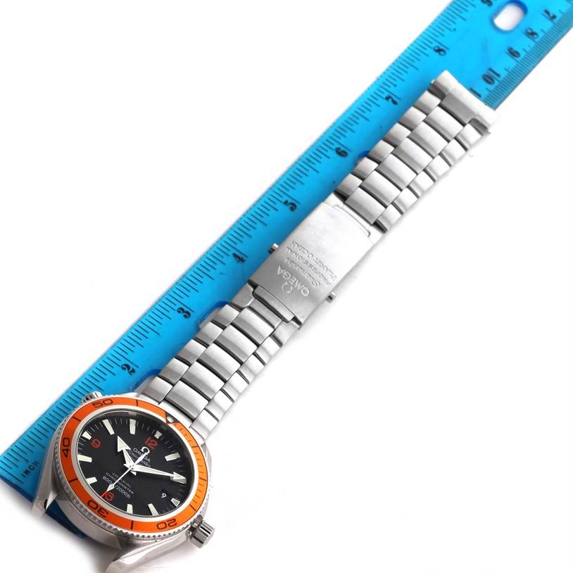 The image shows the Omega Planet Ocean 2209.50.00 Men's Stainless Steel Black Dial 2209.50.00 Men's Stainless Steel Black Dial watch laid flat next to a ruler, displaying the face, bezel, and bracelet.