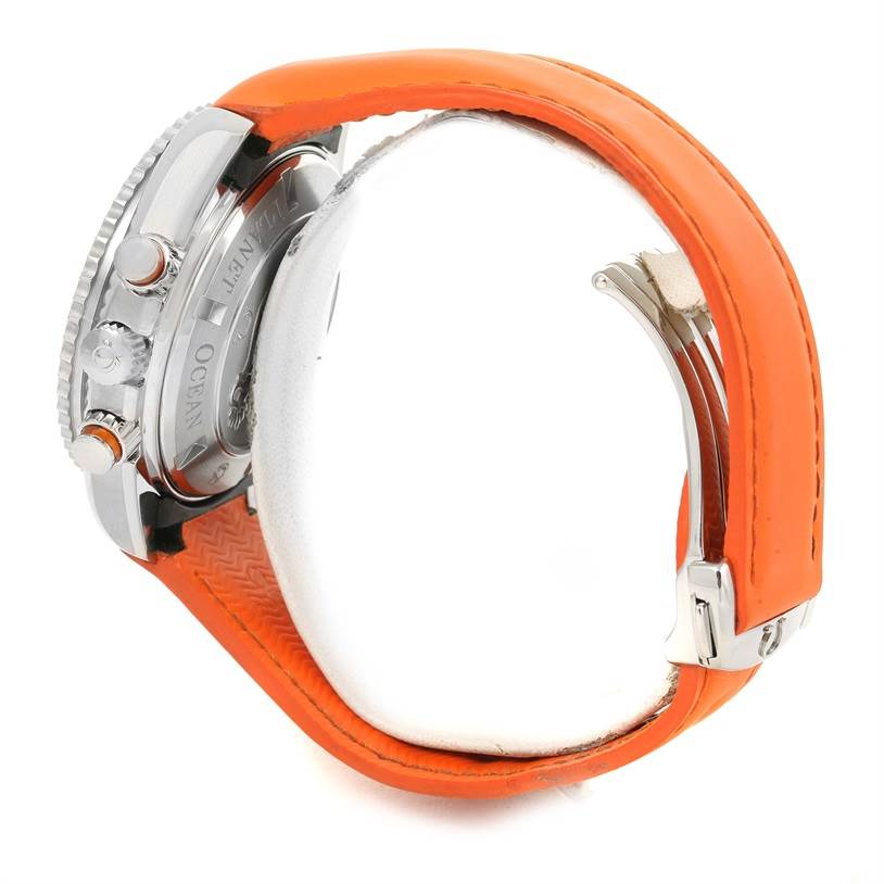 The image shows a side view of an Omega Planet Ocean 2918.50.38 Men
s Stainless Steel Black Dial 2918.50.38 Men
s Stainless Steel Black Dial watch highlighting its orange strap and stainless steel case.