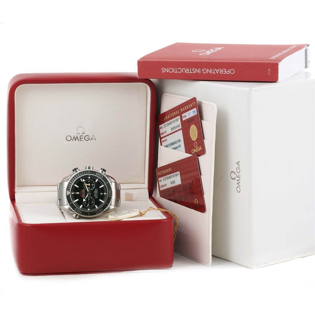 The Omega Planet Ocean 232.30.46.51.01.001 Men
s Stainless Steel Black Dial 232.30.46.51.01.001 Men
s Stainless Steel Black Dial watch is shown in its open box, alongside warranty cards and an operating instructions manual.