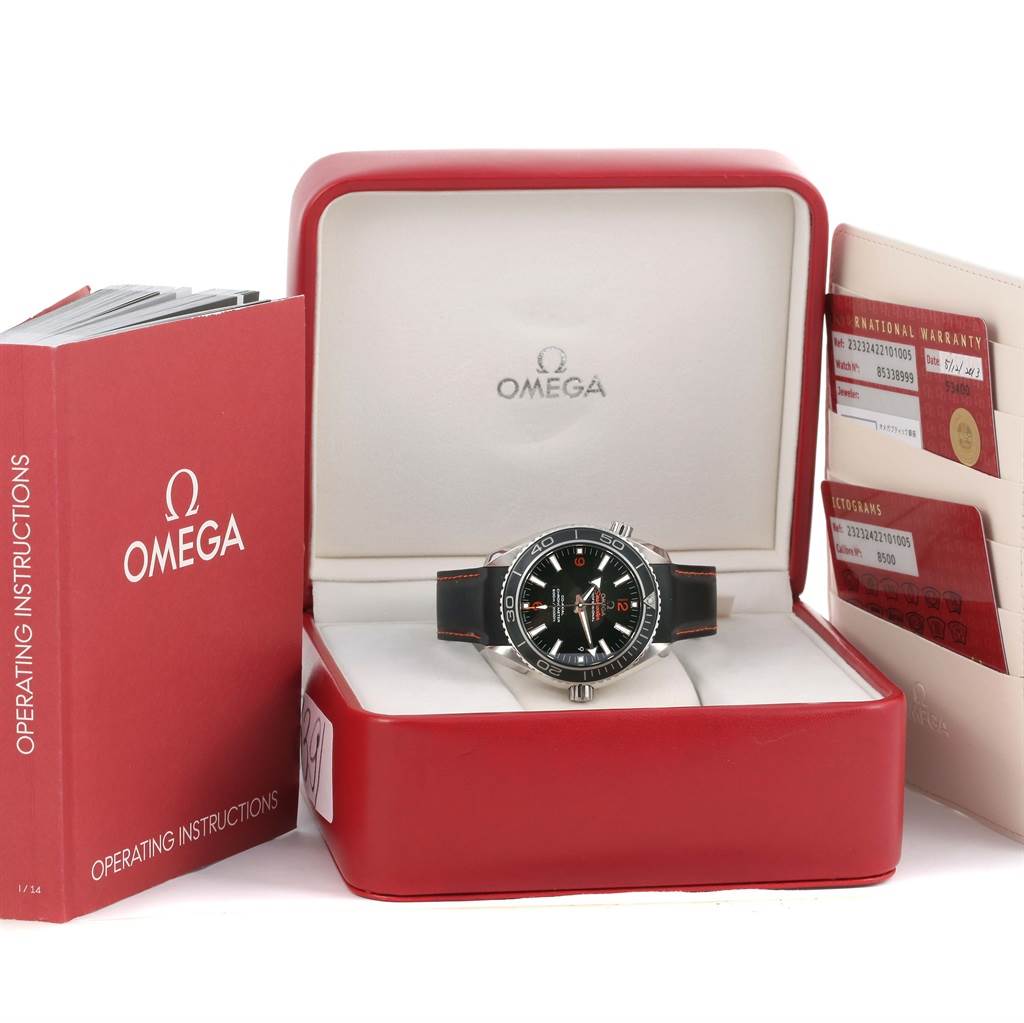 The image shows an Omega Planet Ocean 232.30.42.21.01.003 Men
s Stainless Steel Black Dial 232.30.42.21.01.003 Men
s Stainless Steel Black Dial watch in its box, accompanied by an operating instructions book and warranty cards.