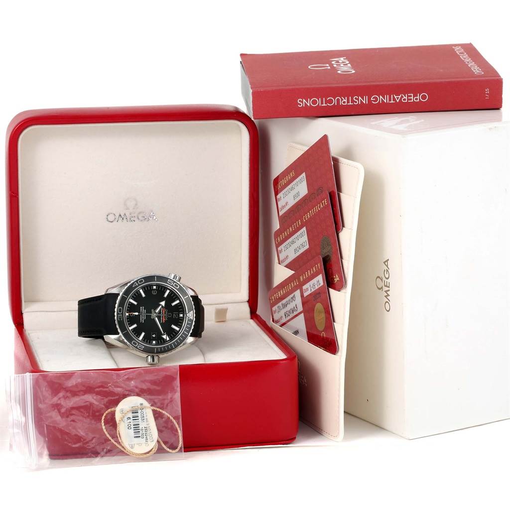The Omega Planet Ocean 232.32.46.21.01.003 Men
s Stainless Steel Black Dial 232.32.46.21.01.003 Men
s Stainless Steel Black Dial watch is shown front-facing inside its box, with warranty cards, operating instructions, and tags included.