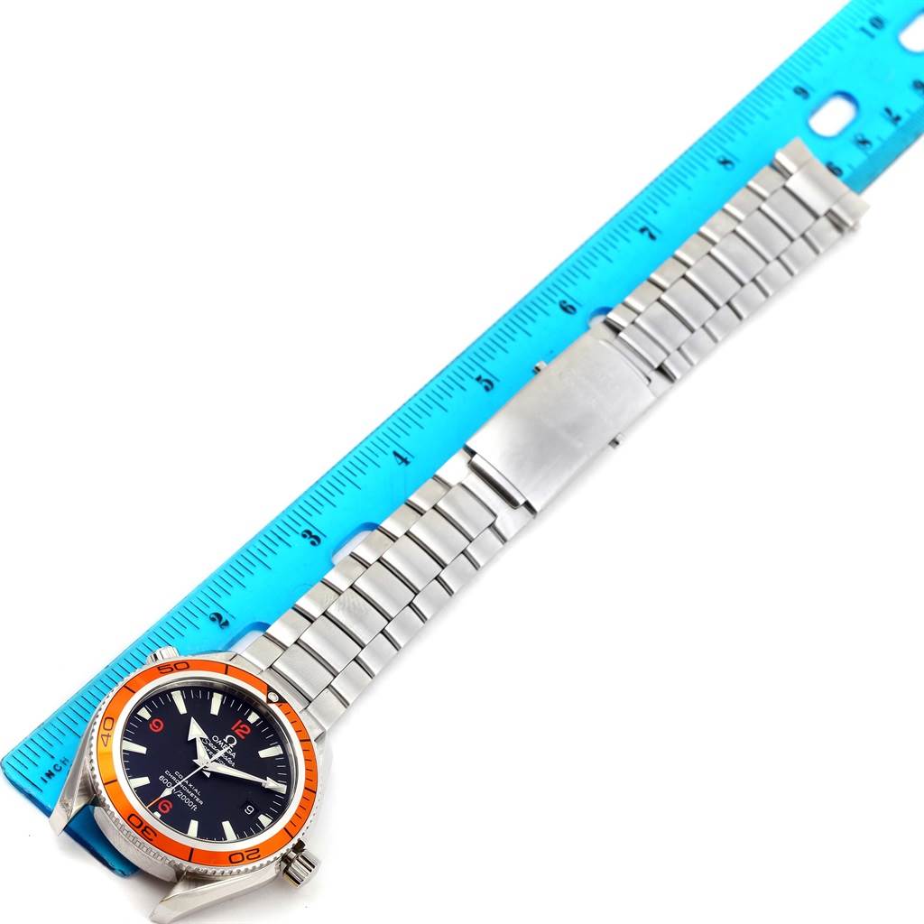 The Omega Planet Ocean 2208.50.00 Men
s Stainless Steel Black Dial 2208.50.00 Men
s Stainless Steel Black Dial watch is displayed laying flat, diagonally aligned with a ruler, showing the full bracelet and watch face.