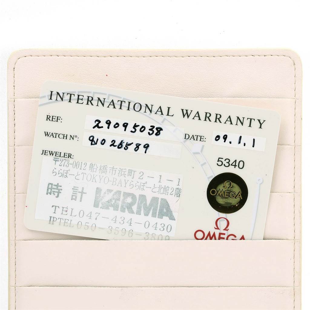 The image shows an Omega Planet Ocean 2909.50.38 Men
s Stainless Steel Black Dial 2909.50.38 Men
s Stainless Steel Black Dial model
s International Warranty card resting in a beige cardholder.