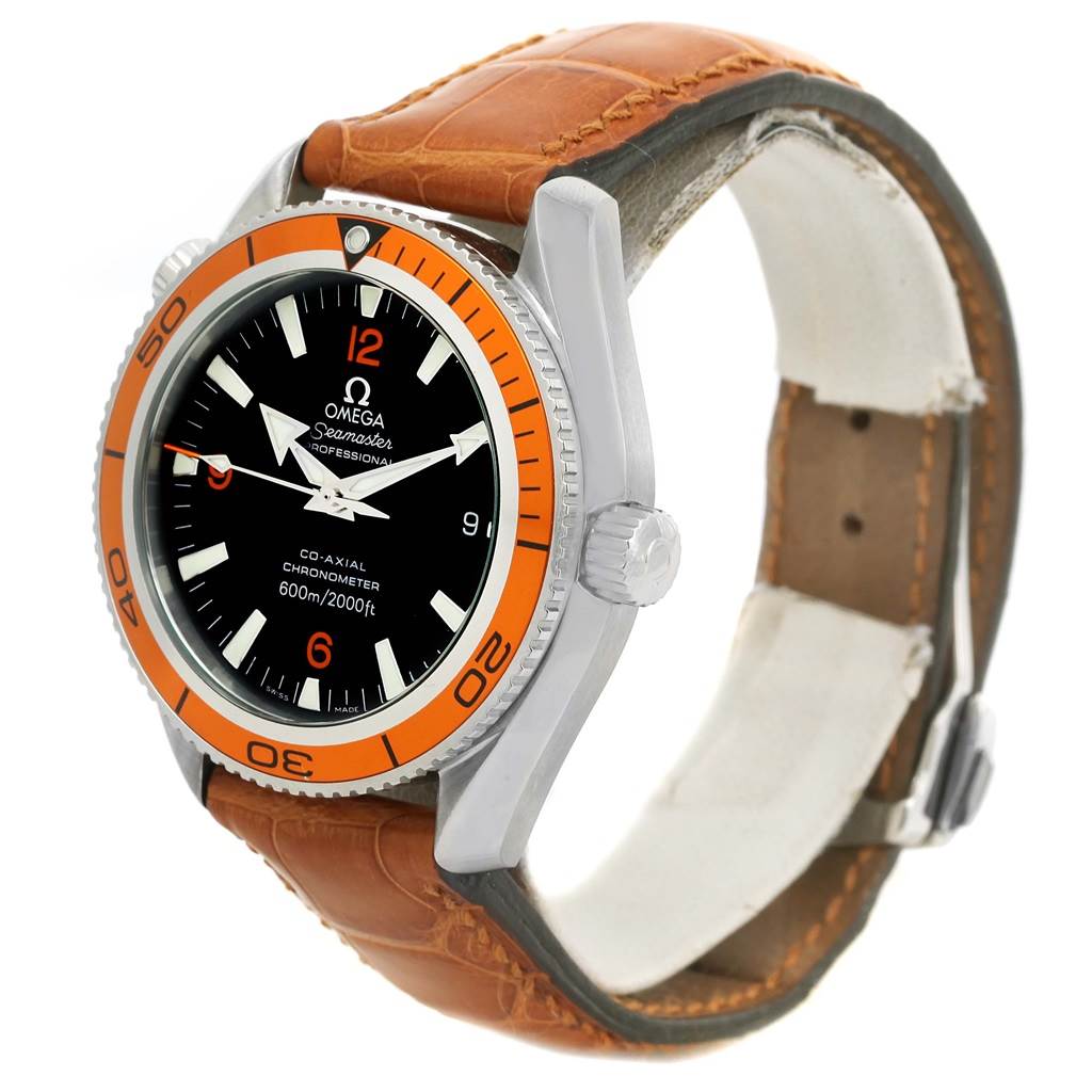 The image shows a Planet Ocean model by Omega at a three-quarter angle, highlighting the dial, bezel, crown, and leather strap.