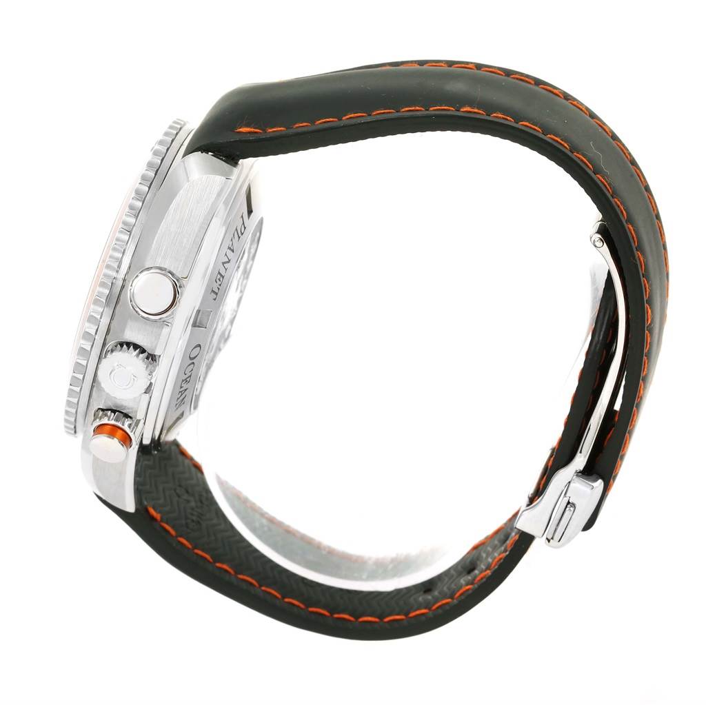 The image shows the side view of an Omega Planet Ocean 2918.50.82 Men
s Stainless Steel Black Dial 2918.50.82 Men
s Stainless Steel Black Dial watch, highlighting its crown, pushers, and black strap with orange stitching.