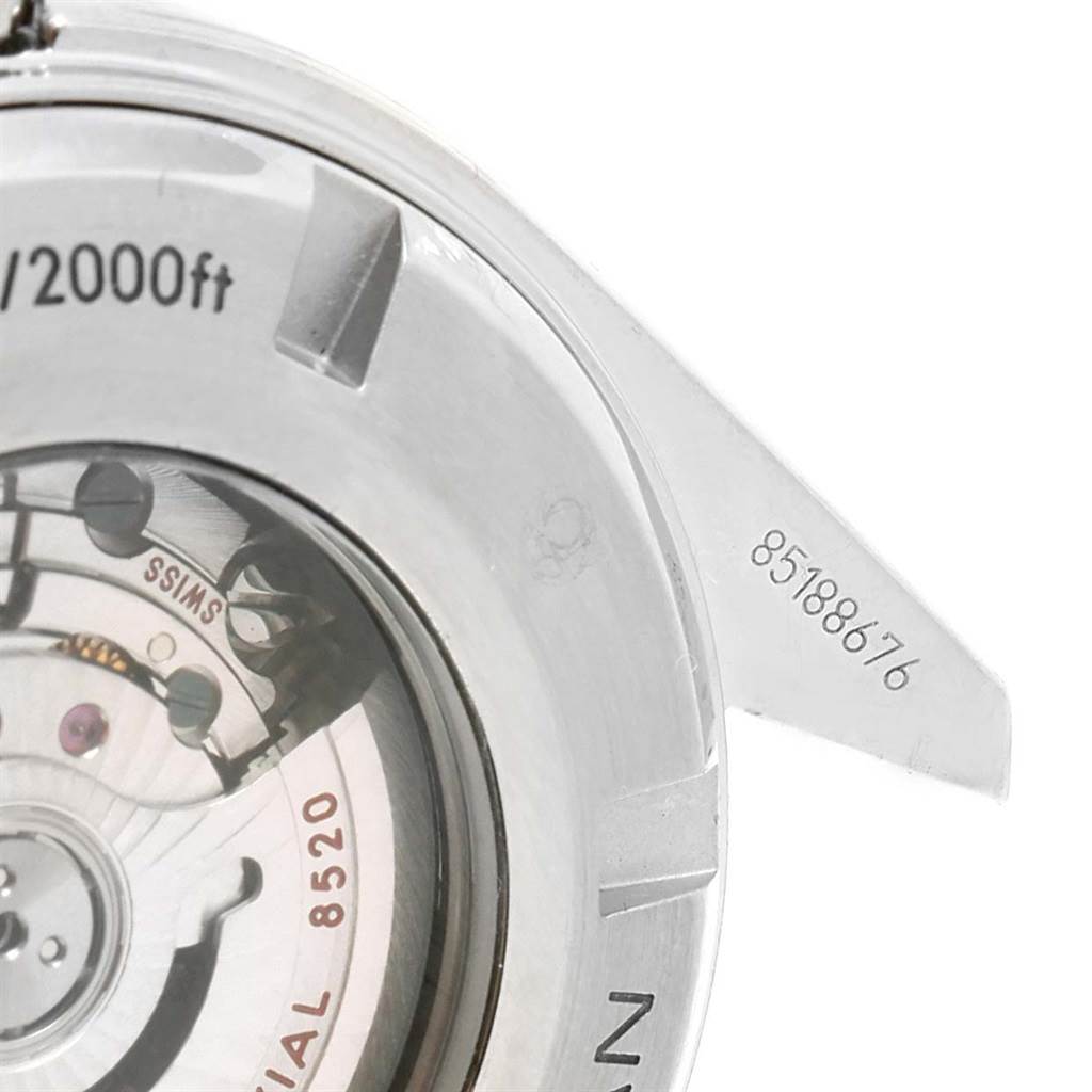 The image shows a close-up of the case back of an Omega Planet Ocean 232.30.38.20.01.002 Men
s Stainless Steel Black Dial 232.30.38.20.01.002 Men
s Stainless Steel Black Dial watch, revealing the movement inside.