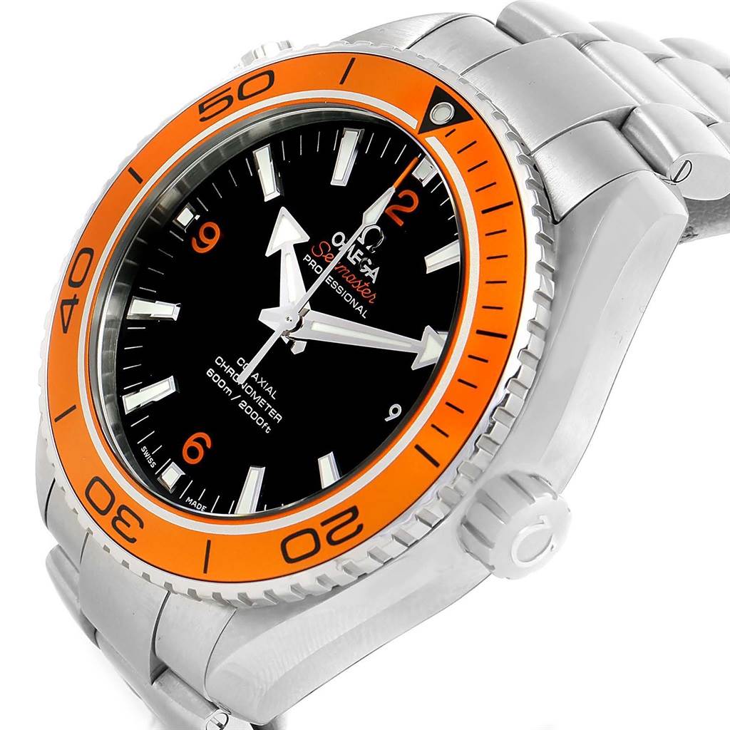 The image shows an angled close-up of an Omega Planet Ocean 232.30.46.21.01.002 Men's Stainless Steel Black Dial 232.30.46.21.01.002 Men's Stainless Steel Black Dial watch, highlighting the orange bezel, black dial, and stainless steel bracelet.