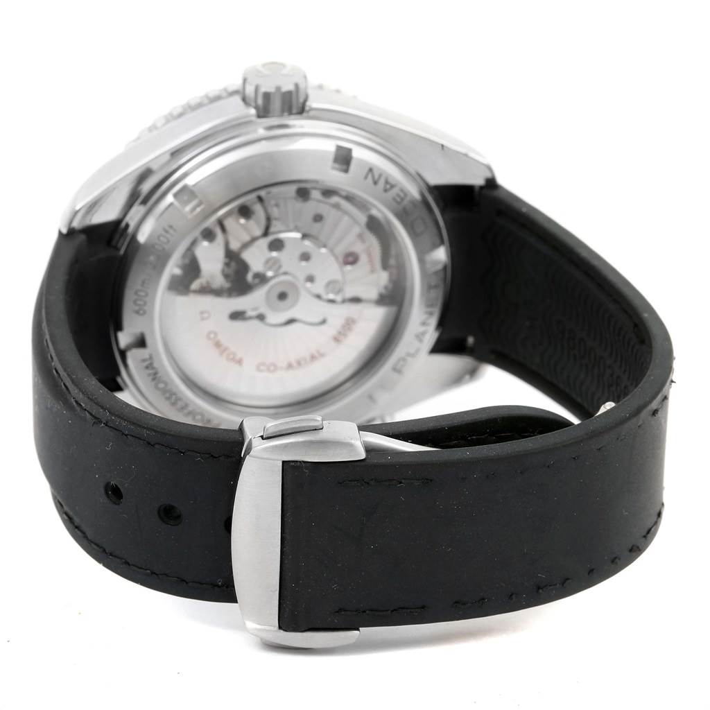 The image shows the back of an Omega Planet Ocean 232.32.46.21.01.003 Men
s Stainless Steel Black Dial 232.32.46.21.01.003 Men
s Stainless Steel Black Dial watch with a visible movement and a black strap.