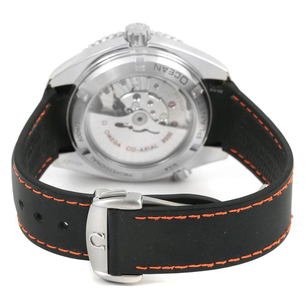 The Omega Planet Ocean 232.32.42.21.01.005 Men
s Stainless Steel Black Dial 232.32.42.21.01.005 Men
s Stainless Steel Black Dial watch is shown from the back, displaying its transparent case back and black strap with orange stitching.