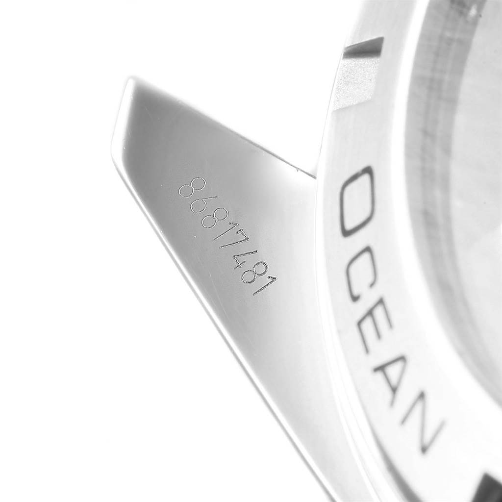 This close-up image shows part of the bezel and serial number of an Omega Planet Ocean 232.30.46.21.01.001 Men
s Stainless Steel Black Dial 232.30.46.21.01.001 Men
s Stainless Steel Black Dial watch.