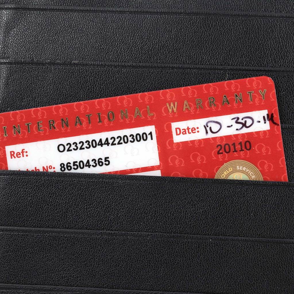 The image shows the International Warranty card for the Omega Planet Ocean 232.30.44.22.03.001 Men
s Stainless Steel Blue Dial 232.30.44.22.03.001 Men
s Stainless Steel Blue Dial watch, partially inserted into a black holder.