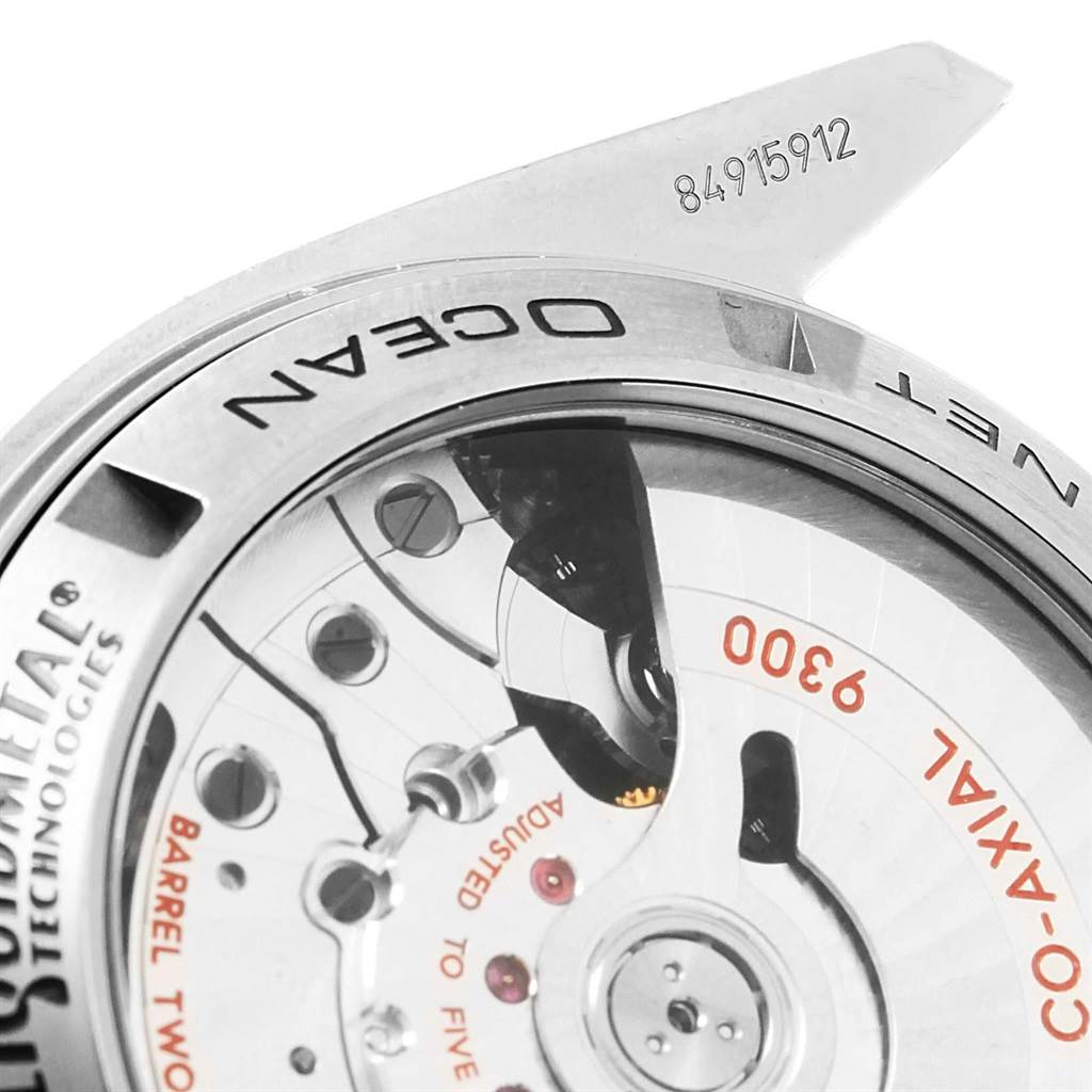 This image shows a close-up back view of the Omega Planet Ocean 232.90.46.51.03.001 Men's Titanium Blue Dial 232.90.46.51.03.001 Men's Titanium Blue Dial watch, highlighting its co-axial movement and serial number.